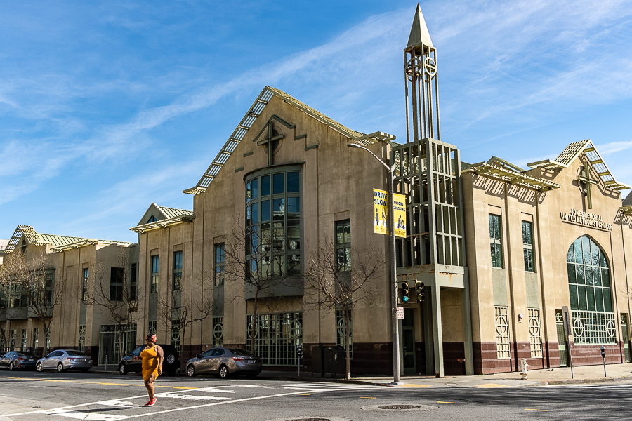 A woman in orange and a&nbsp;church